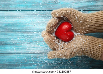 Female Hands In Beige Gloves Holding Red Heart