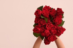Female Hands With Bouquet Of Beautiful Red Roses On White Background. Valentine's Day Celebration