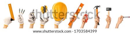 Female hands with builder's supplies on white background