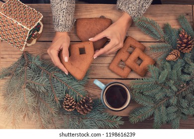 Female Hands Collect Gingerbread House, Top View