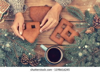 Female Hands Collect Gingerbread House, Top View