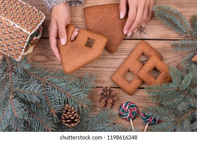 Female Hands Collect Gingerbread House, Top View