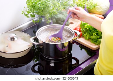 Female Hands Cooking Vegetable Soup In The Kitchen