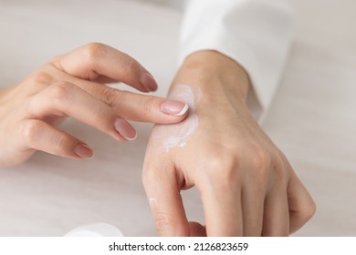 Female Hands With Cream. Woman Applies Cream On Her Hands. Palms Down With Smooth Skin On Hands, Nice Natural Short Nails.