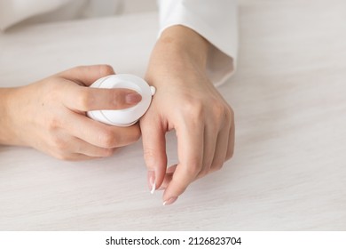 Female Hands With Cream. Woman Applies Cream On Her Hands. Palms Down With Smooth Skin On Hands, Nice Natural Short Nails.