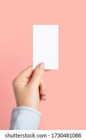 Female Hands With Cutaway, Blank Menu, Discount Card, Business Card On Color Pink Beauty Background With Copy Space. Template For Design. Vertical Photo. Mockup