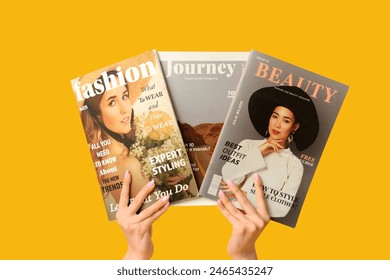 Female hands with different magazines on yellow background