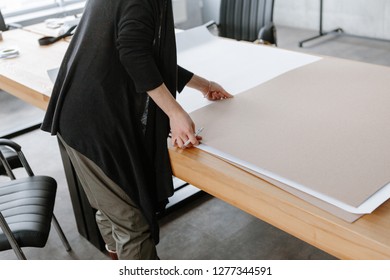 Female hands are drawing on a large wooden table in the loft style in the office - Shutterstock ID 1277344591
