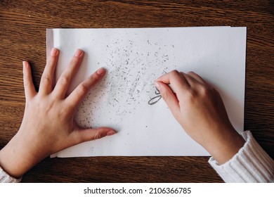 Female hands erase inscription stress with rubber band from white sheet of paper