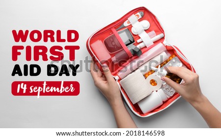 Female hands with first aid kit on white background