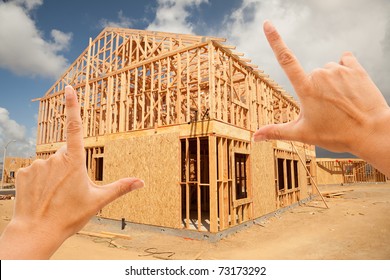 Female Hands Framing New Home Frame On Construction Site.