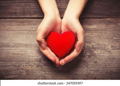 Female Hands Giving Red Heart