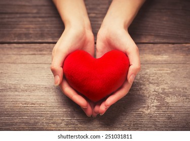 Female Hands Giving Red Heart