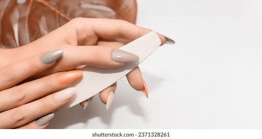 Female hands with glitter nail polish. Gray and orange nail design with two shades. Women hands with sparkle colored manicure - Powered by Shutterstock