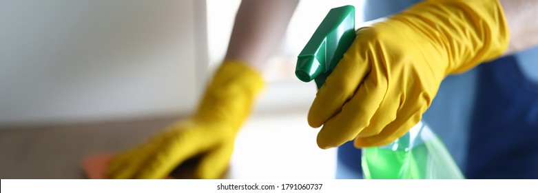 Female hands in gloves disinfect table at home. Thorough cleaning workplace. Hand glove wipes surface table with towel. Apartment and office cleaning. Pandemic housing disinfection - Powered by Shutterstock