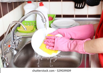 Female Hands In Gloves With Sponge Washing Dish