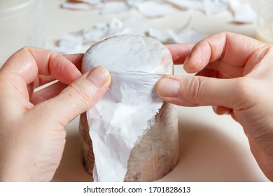 Female Hands Glue A Glass With Scraps Of Paper In The Process Of Creating Paper Mache