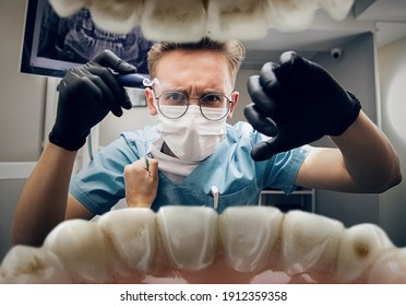 Female hands grip the robe off. Doctor looking into mouth, checking, examining teeth. Using tools and equipments. Healthcare and medicine, stomatology, feelings of patient. Look from inside the teeth.