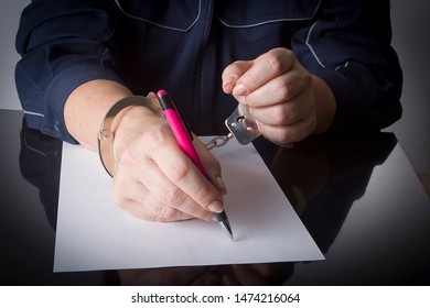 Female Hands Handcuffed With A Pen And A Sheet Of White Paper