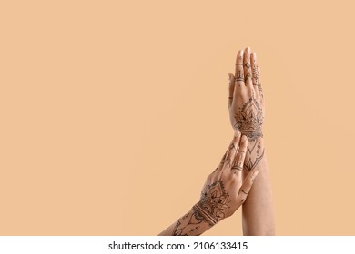 Female hands with henna tattoo on color background - Powered by Shutterstock