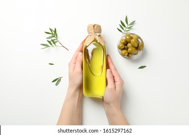 Female hands hold bottle with olive oil on white background, top view - Shutterstock ID 1615297162