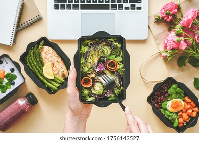 Female Hands Hold Food Delivery Box Having Lunch At Work From Home Office. Business Woman Worker Eats Salad Take Away Nutrition Daily Healthy Meal Weight Loss Diet Menu At Workplace Flat Lay Top View.