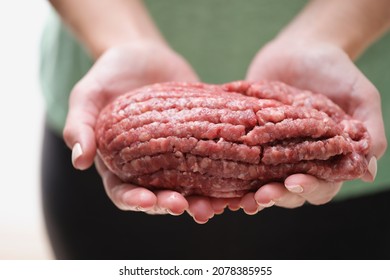 Female hands hold fresh minced meat, close-up - Powered by Shutterstock