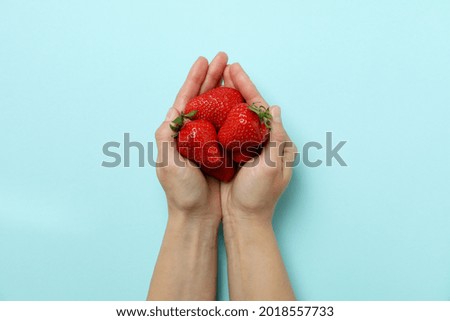 Similar – Woman holds strawberries in her hands