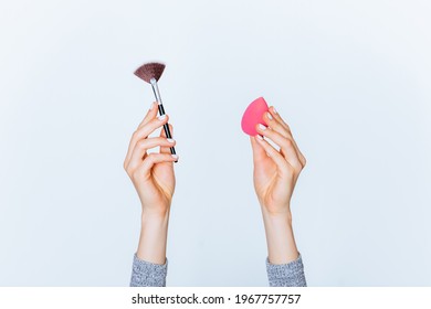 Female Hands Hold Makeup Tools Powder Brush And Sponge On White Background