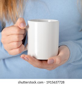 Female hands hold mock up white empty mug, cup for your design and logo closeup. Template blank for promotional text message or promotional content - Shutterstock ID 1915637728