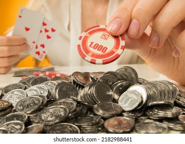 Female Hands Hold A Poker Chip. A Poker Chip With The Number One Thousand And An Empty Space For Inscriptions In Female Hands Close-up Isolated