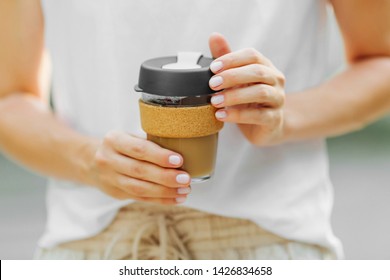 Female Hands Hold Reusable Coffee Mug. Take Your Coffee To-go With Reusable Travel Mug. Zero Waste. Sustainable Lifestyle Concept.
