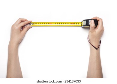 A female hands hold a yellow tape measure isolated white, top view at the studio. - Shutterstock ID 234187033