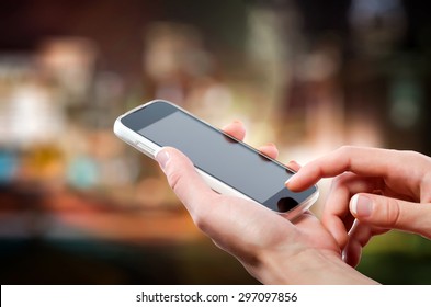 Female Hands Holding A Cell Phone (smartphone) With Tuchscreen In Night