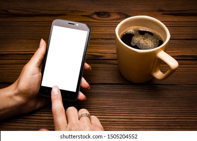 Female hands holding cup of coffee on wooden background - Shutterstock ID 1505204552