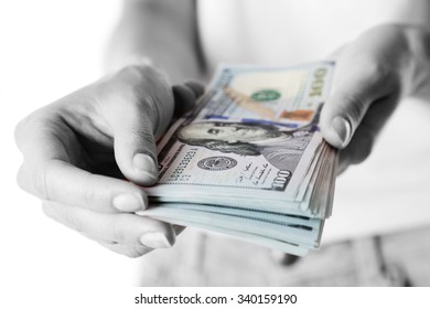Female hands holding dollars, closeup