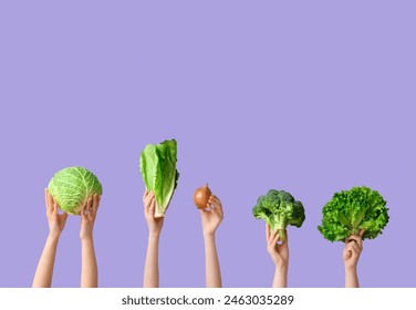 Female hands holding fresh vegetables on lilac background - Powered by Shutterstock