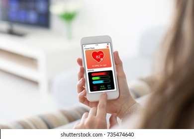 Female Hands Holding Phone With App Health Tracking Activity On Screen In Room