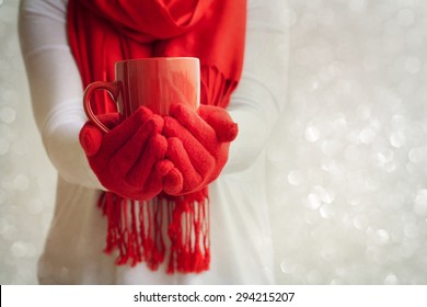 Female Hands Holding A Red Mug