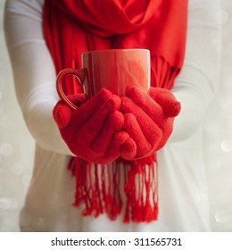 Female Hands Holding A Red Mug