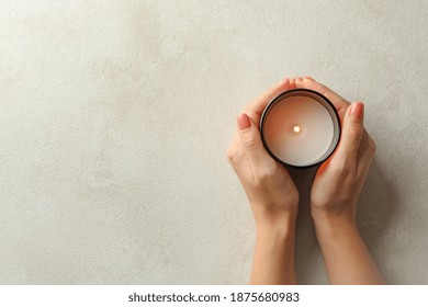 Female hands holding scented candle, top view - Powered by Shutterstock