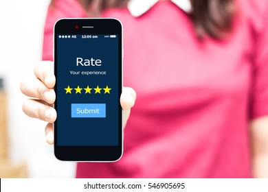 Female hands holding smart phone Rate your experience,high key