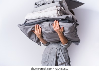 female hands holding stack monochrome gradient white gray black bed linen textiles clothing background pile concept