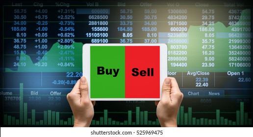 female hands holding a tablet touch screen showing buy and sell over the Stock market chart,Closeup Stock market exchange data on LED display, business trading concept