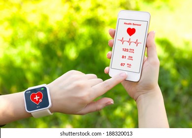 Female Hands Holding Touch Phone And Smart Watch With Mobile App Health Sensor