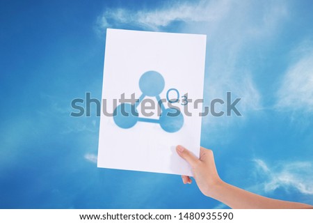 Female hands holding white paper with sign ozone o3 in blue sky background./Ozone concept 