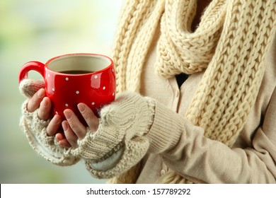 Female hands with hot drink, on light background - Shutterstock ID 157789292