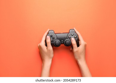 Female Hands With Joypad On Color Background