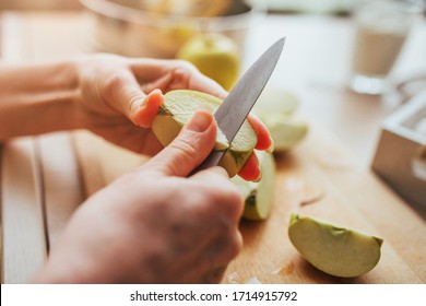 Female Hands With A Knife Cut Out A Core From An Apple - Cooking Closeup