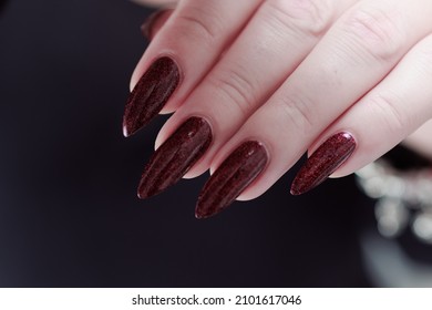 Female Hands With Long Nails And Dark Red Nail Polish